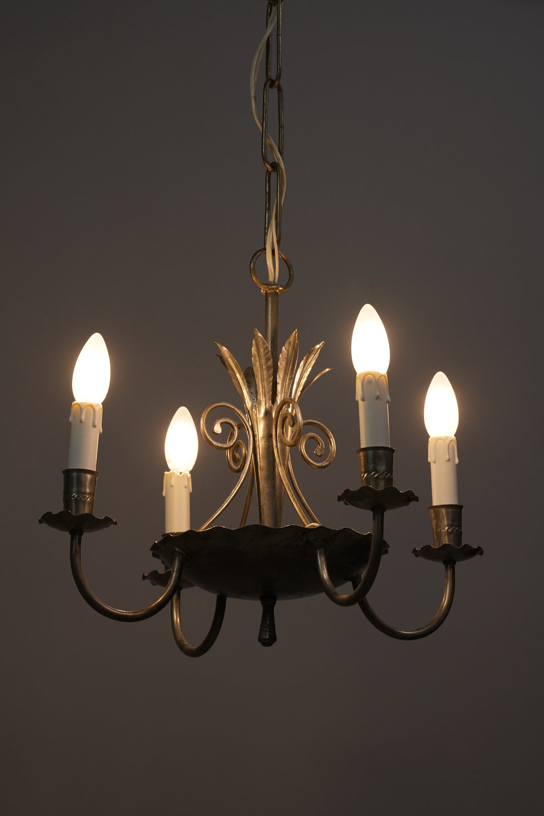 Detailed wrought iron ceiling lamp. Has four holders for lamps or candles.
